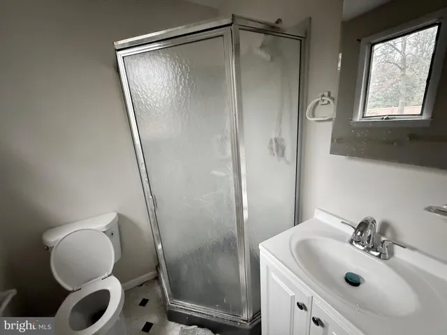 a bathroom with a sink mirror vanity and toilet