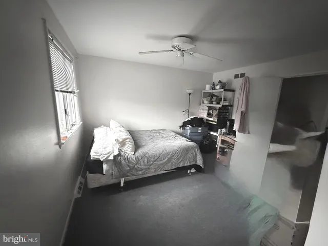 a bedroom with bed and window