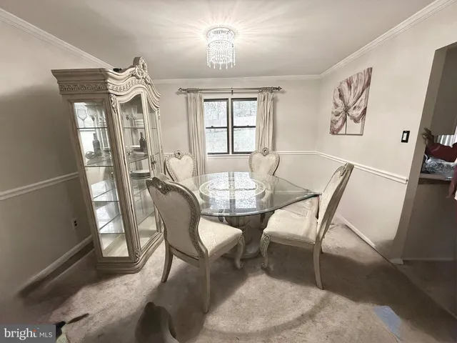 a view of a dining room with furniture and chandelier