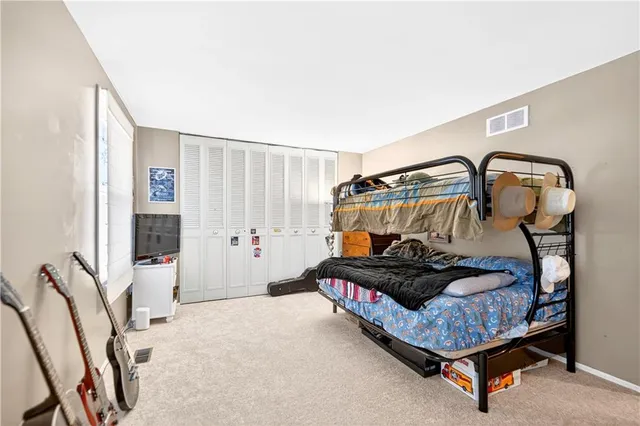 a bedroom with furniture and a window