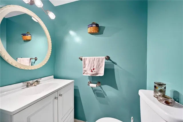 a bathroom with a sink mirror and toilet