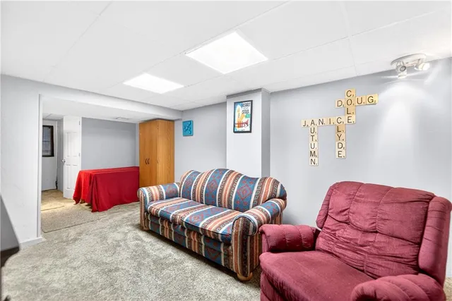 a living room with furniture a couch and dresser