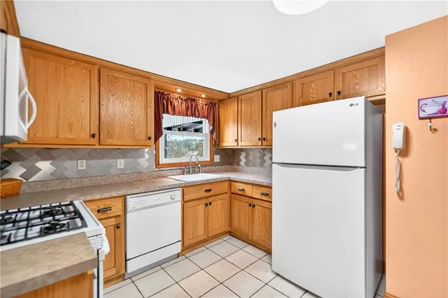 a kitchen with a refrigerator a sink and cabinets