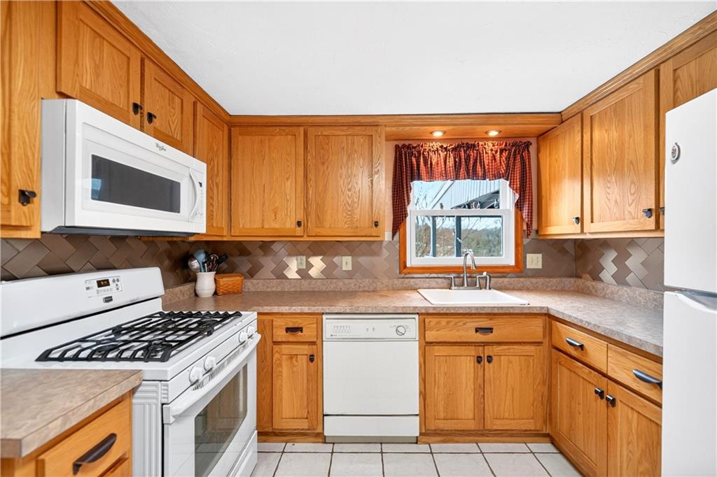 37 Hones Road Export, PA 15632 - Photo 5 of 37 a kitchen with stainless steel appliances granite countertop a stove a sink and a microwave