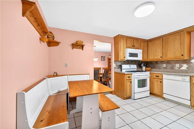 a kitchen with granite countertop a sink cabinets and stainless steel appliances