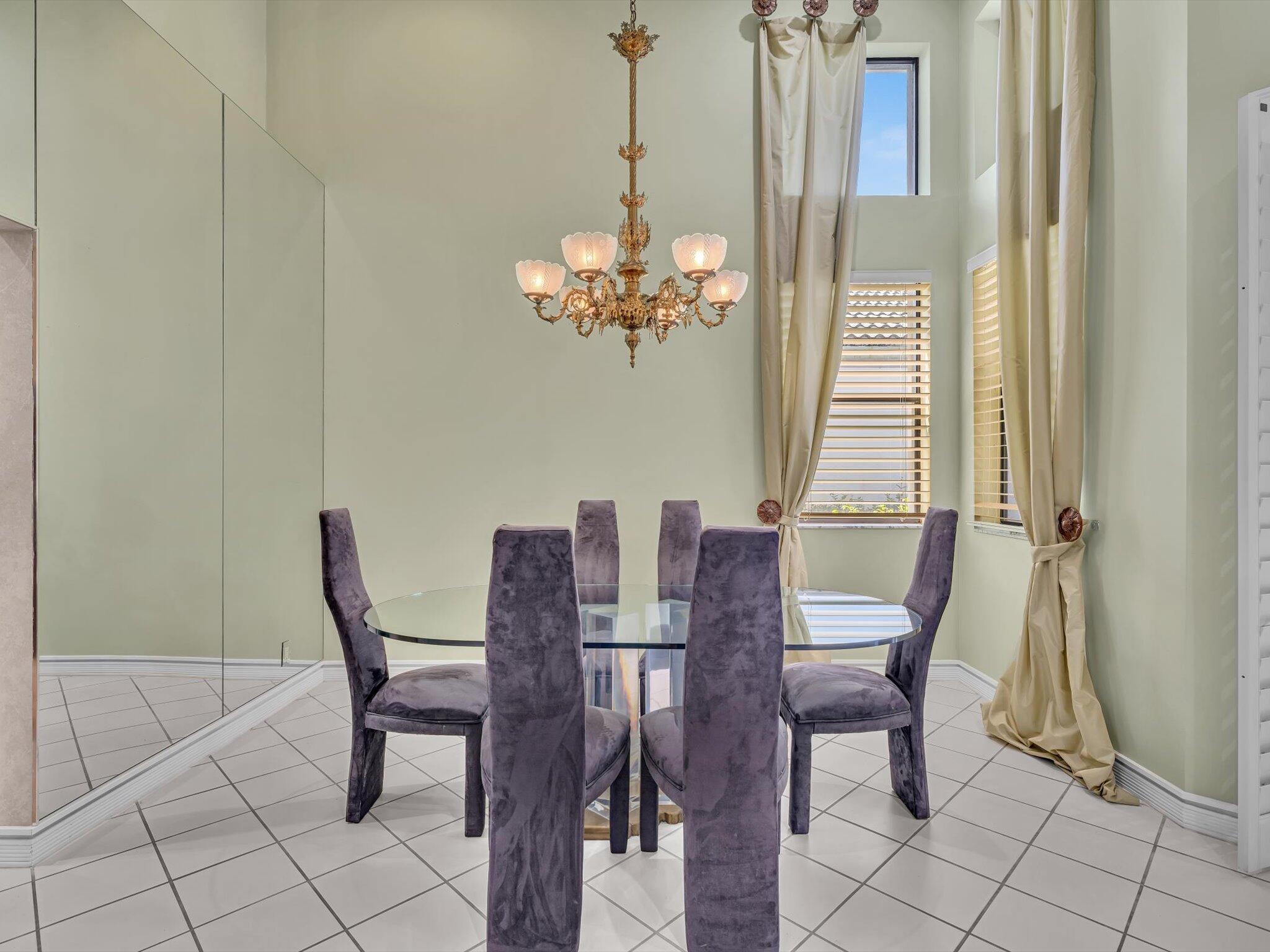 10122 Spyglass Way Boca Raton, FL 33498 - Photo 23 of 65 a view of a dining room with furniture and chandelier