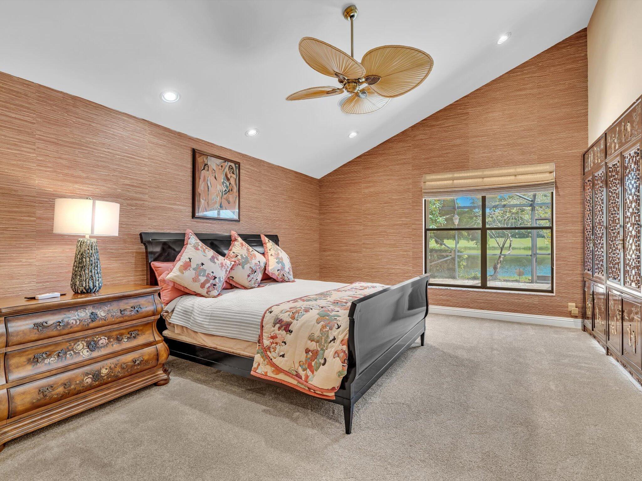 10122 Spyglass Way Boca Raton, FL 33498 - Photo 26 of 65 a spacious bedroom with a bed chandelier painting on the wall and a large window