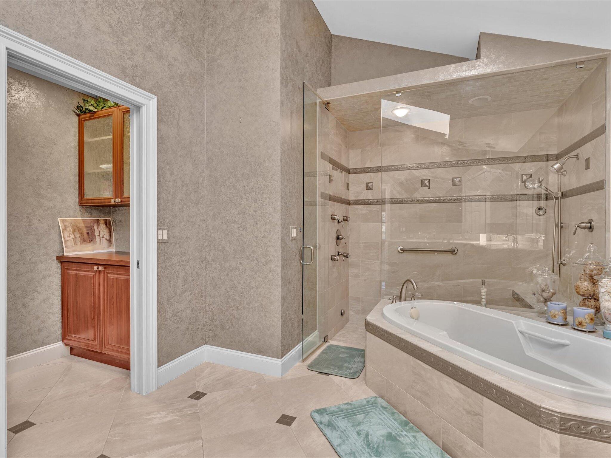 10122 Spyglass Way Boca Raton, FL 33498 - Photo 32 of 65 a bathroom with a tub and shower