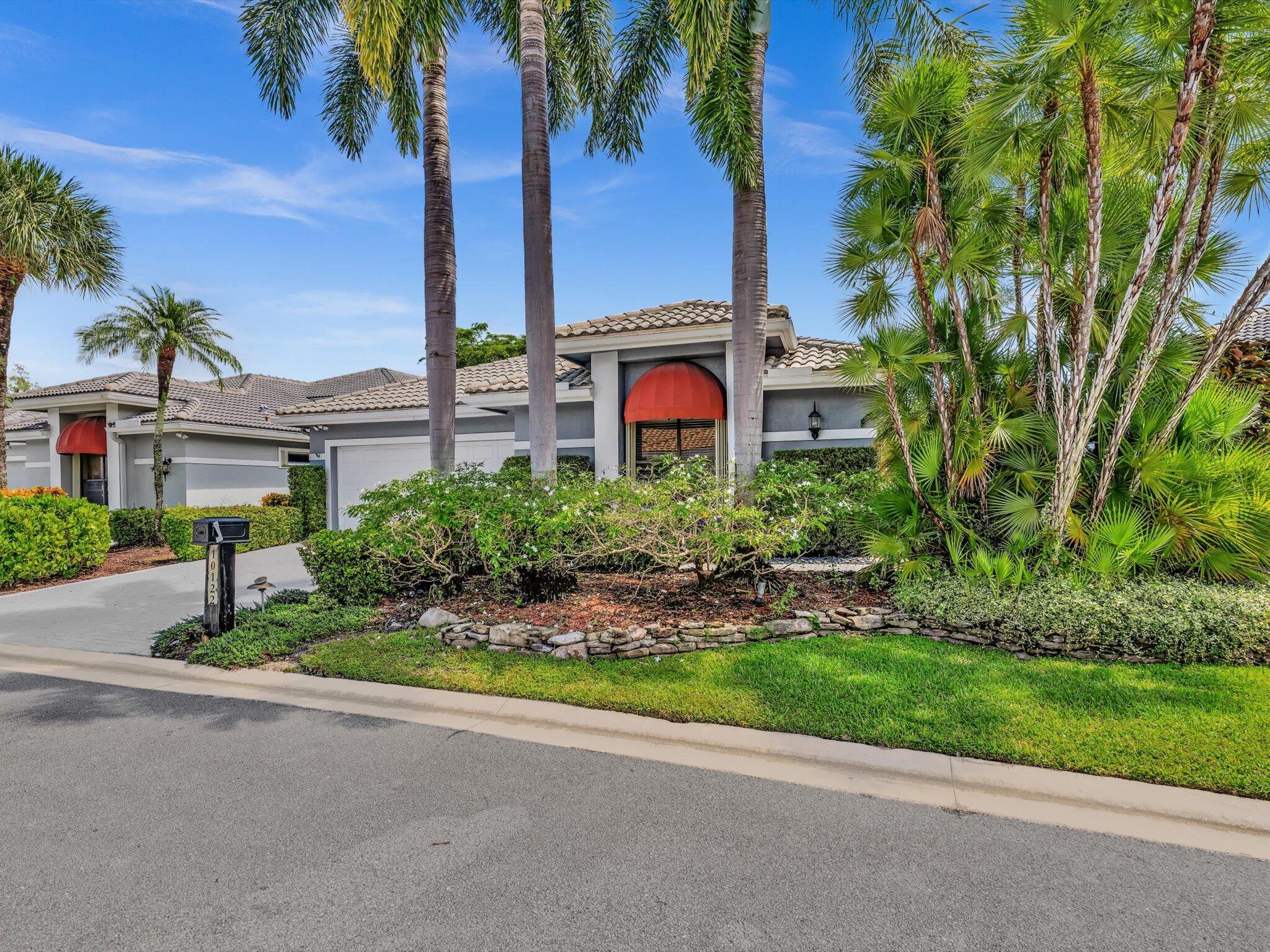 10122 Spyglass Way Boca Raton, FL 33498 - Photo 39 of 65 front view of a house with a garden
