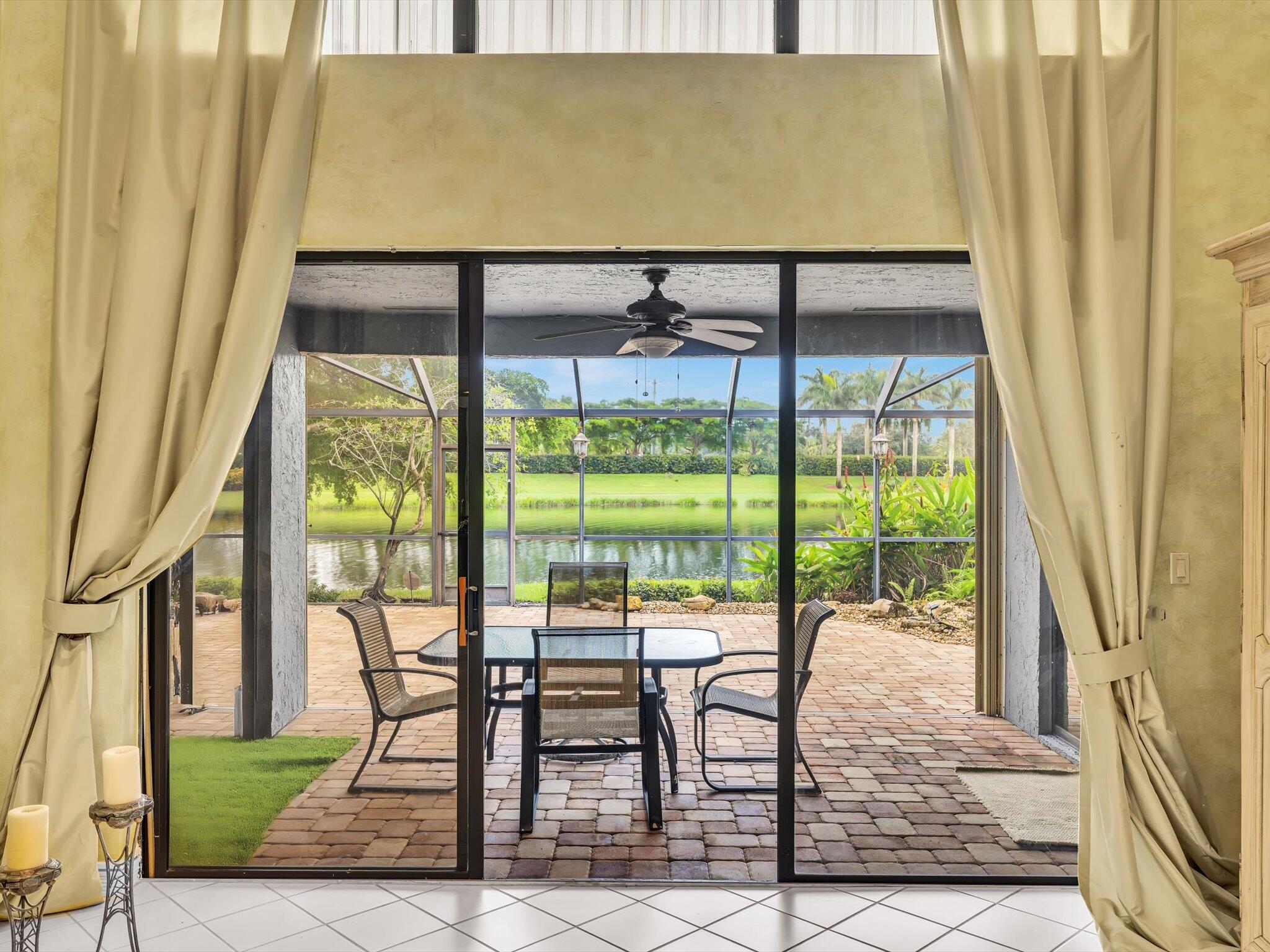 10122 Spyglass Way Boca Raton, FL 33498 - Photo 4 of 65 a view of a living room and floor to ceiling window