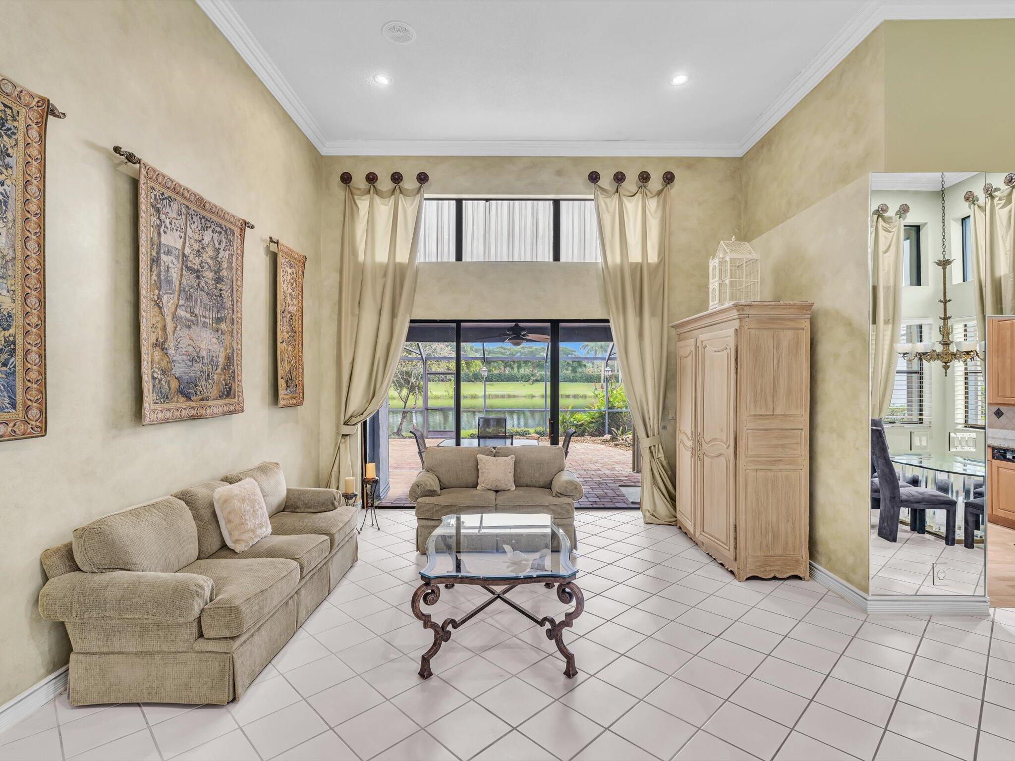 10122 Spyglass Way Boca Raton, FL 33498 - Photo 5 of 65 a living room with furniture and a large window