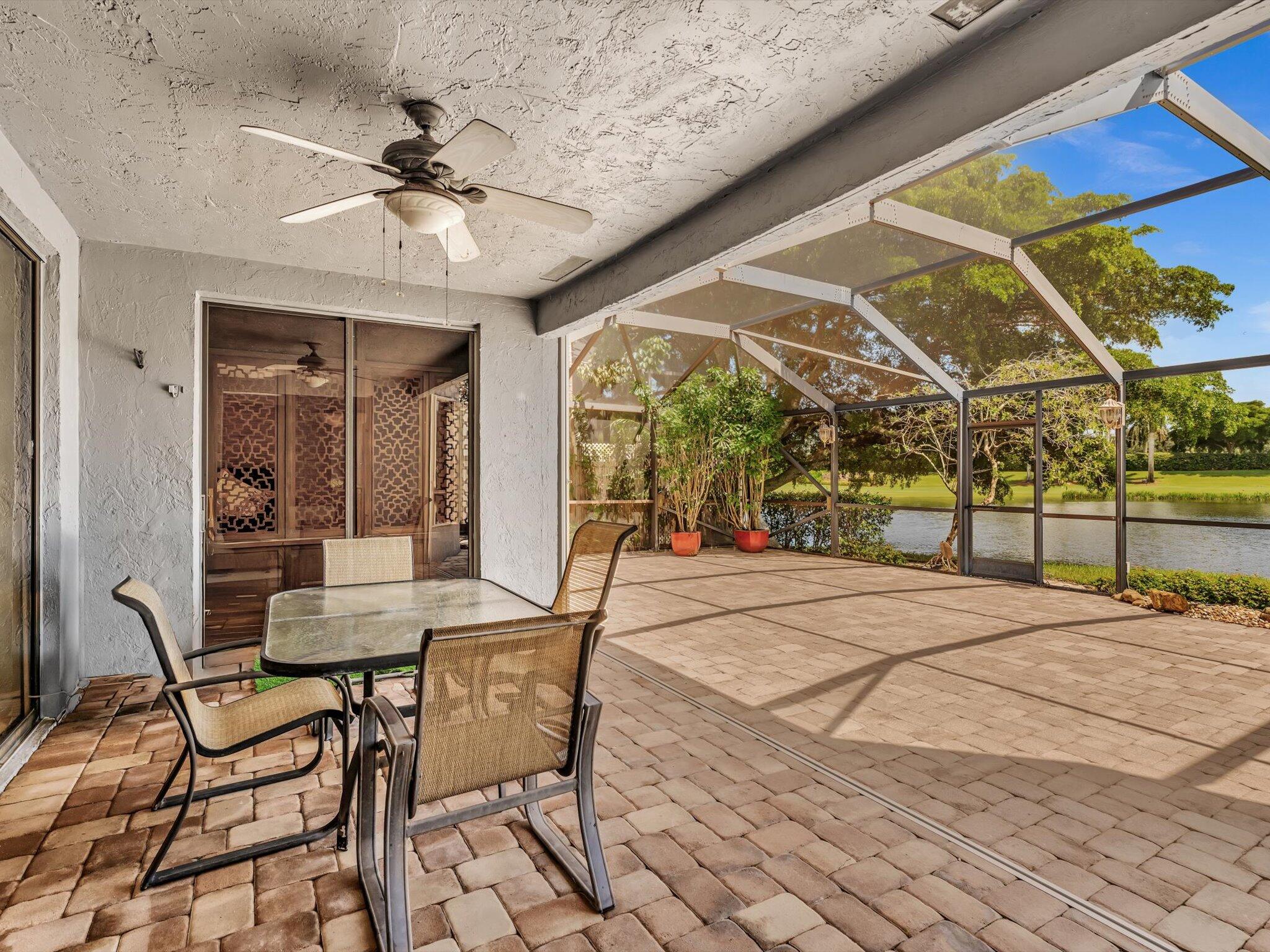 10122 Spyglass Way Boca Raton, FL 33498 - Photo 7 of 65 a view of a patio with a table and chairs