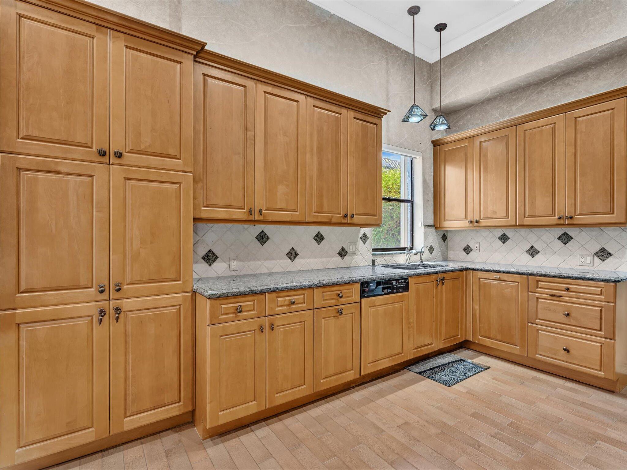 10122 Spyglass Way Boca Raton, FL 33498 - Photo 9 of 65 a kitchen with white cabinets and white appliances