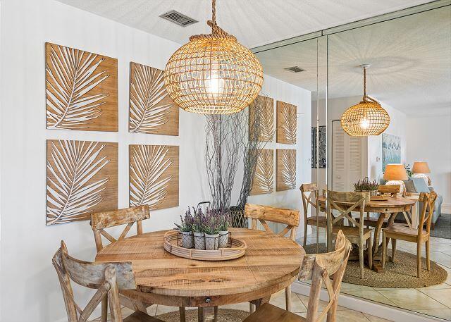 1030 East US Highway 98, Unit 203A Destin, FL 32541 - Photo 11 of 35 a view of a dining room with furniture wooden floor and chandelier