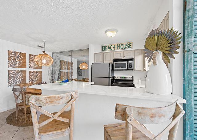 1030 East US Highway 98, Unit 203A Destin, FL 32541 - Photo 13 of 35 a view of a kitchen with furniture and a fireplace