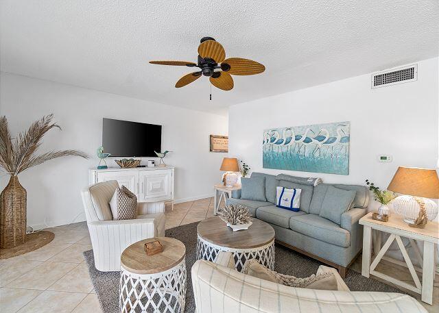 1030 East US Highway 98, Unit 203A Destin, FL 32541 - Photo 14 of 35 a living room with furniture a dining table and a fireplace