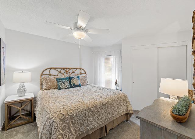 1030 East US Highway 98, Unit 203A Destin, FL 32541 - Photo 15 of 35 a bedroom with a bed and lamp on the dresser