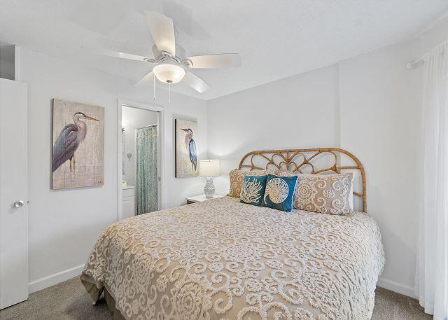 1030 East US Highway 98, Unit 203A Destin, FL 32541 - Photo 16 of 35 a bedroom with a bed and a mirror