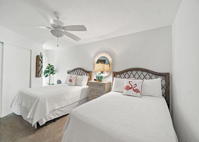 1030 East US Highway 98, Unit 203A Destin, FL 32541 - Photo 19 of 35 a bedroom with two beds and a window