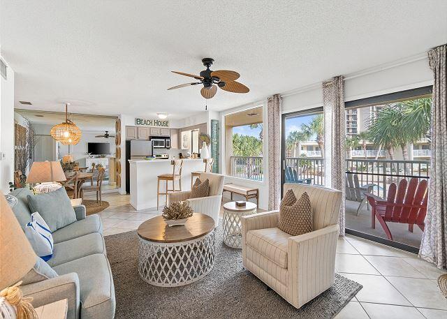 1030 East US Highway 98, Unit 203A Destin, FL 32541 - Photo 2 of 35 a living room with furniture a rug potted plant and a large window