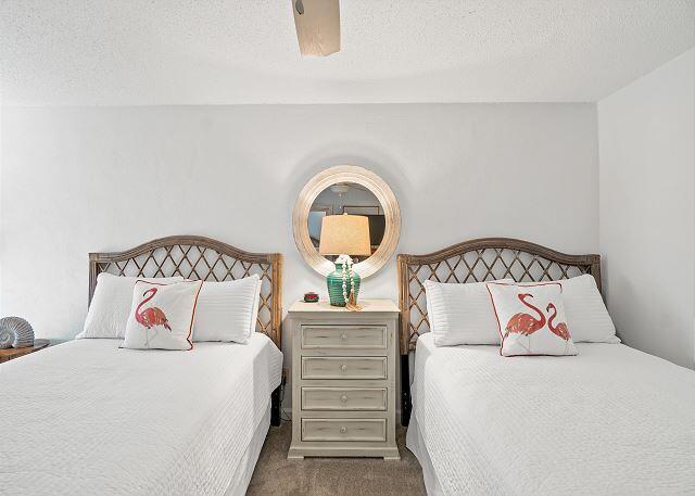 1030 East US Highway 98, Unit 203A Destin, FL 32541 - Photo 21 of 35 a bedroom with a bed and a painting on the wall