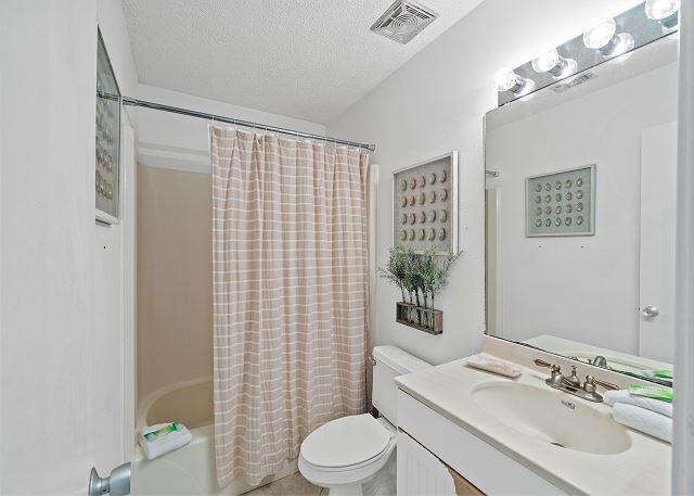 1030 East US Highway 98, Unit 203A Destin, FL 32541 - Photo 24 of 35 a bathroom with a sink toilet and shower