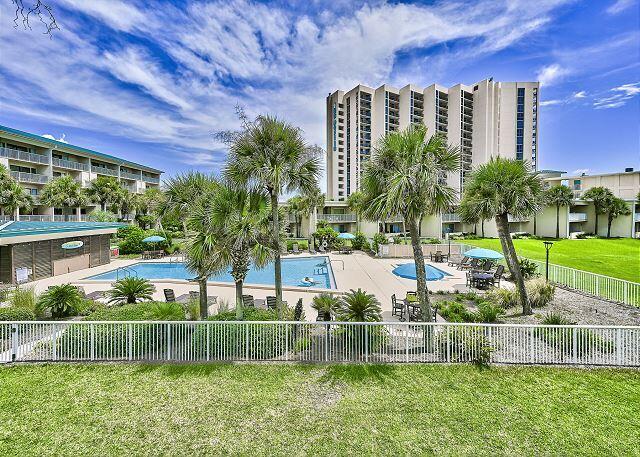 1030 East US Highway 98, Unit 203A Destin, FL 32541 - Photo 27 of 35 a front view of a house with a yard table and chairs