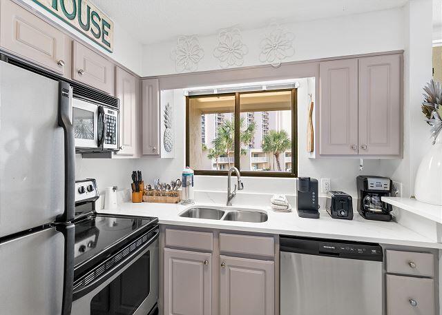 1030 East US Highway 98, Unit 203A Destin, FL 32541 - Photo 9 of 35 a kitchen with a sink appliances cabinets and a window