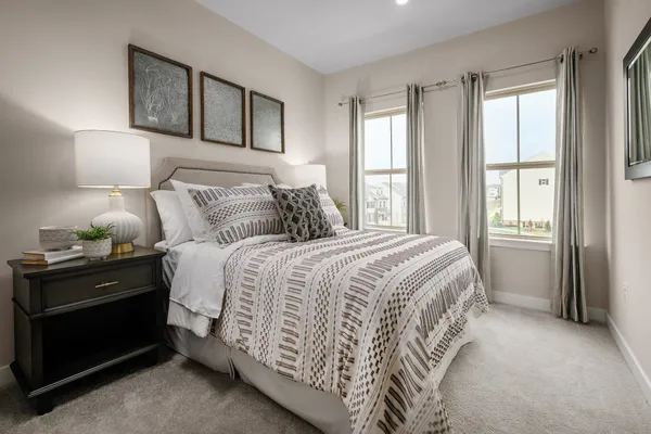 a bedroom with a bed and a night stand