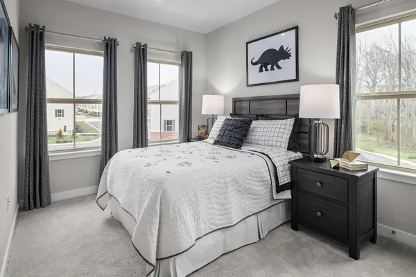 a bed sitting in a bedroom next to a window