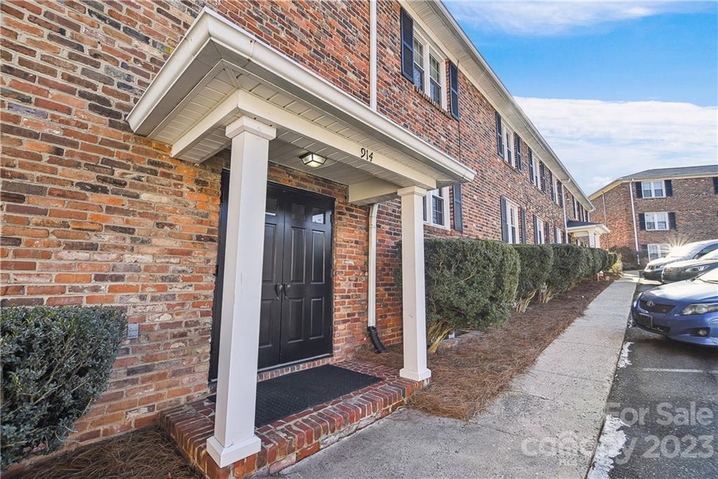 a view of a brick house with many windows