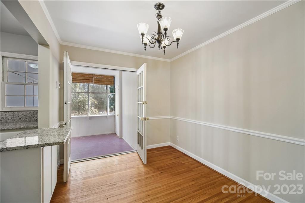 914 McAlway Road Charlotte, NC 28211 - Photo 11 of 44 a view of an empty room with wooden floor and a window