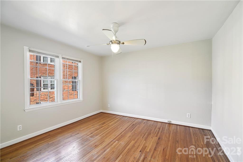 914 McAlway Road Charlotte, NC 28211 - Photo 23 of 44 an empty room with wooden floor fan and windows