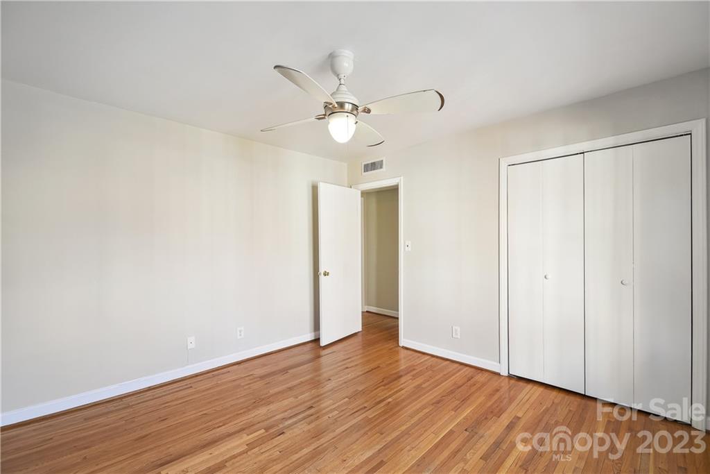 914 McAlway Road Charlotte, NC 28211 - Photo 25 of 44 an empty room with wooden floor fan and windows