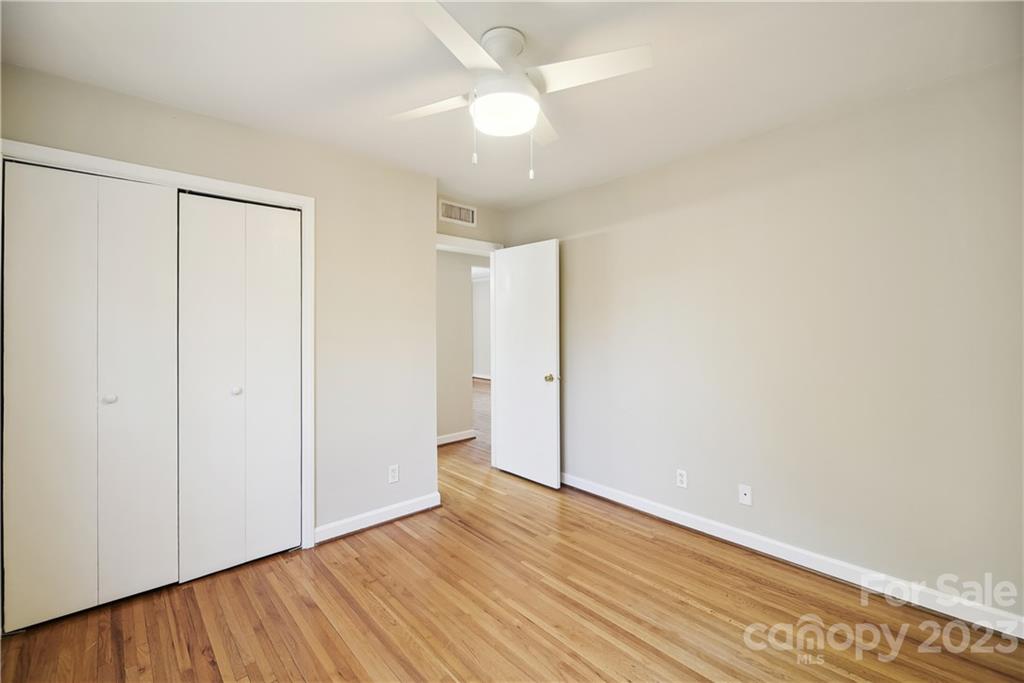 914 McAlway Road Charlotte, NC 28211 - Photo 29 of 44 an empty room with wooden floor and a ceiling fan