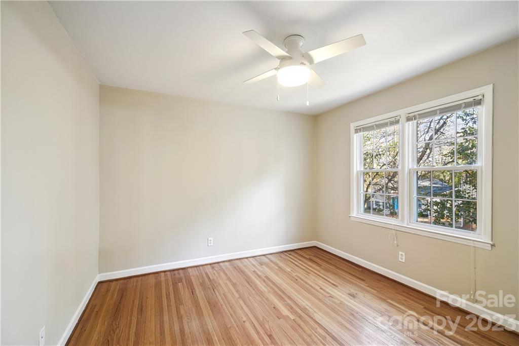 914 McAlway Road Charlotte, NC 28211 - Photo 31 of 44 an empty room with a window and wooden floor