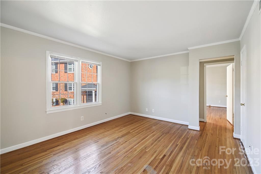 914 McAlway Road Charlotte, NC 28211 - Photo 4 of 44 a view of an empty room with wooden floor and a window