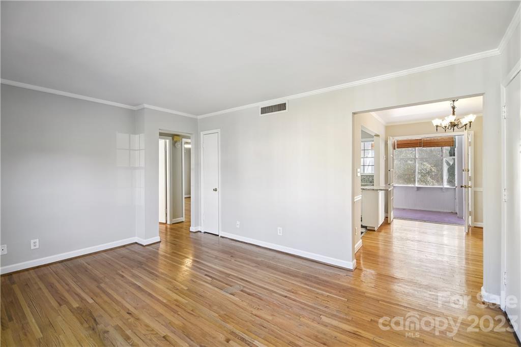 914 McAlway Road Charlotte, NC 28211 - Photo 6 of 44 a view of an empty room with wooden floor and a window