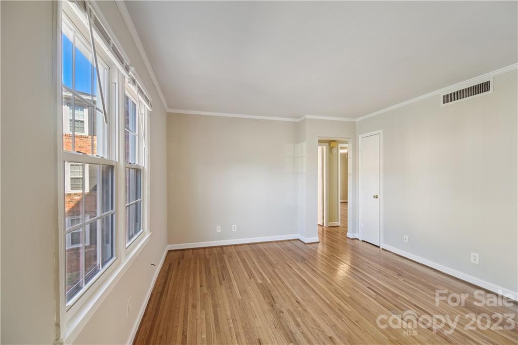 914 McAlway Road Charlotte, NC 28211 - Photo 7 of 44 a view of an empty room with wooden floor and a window