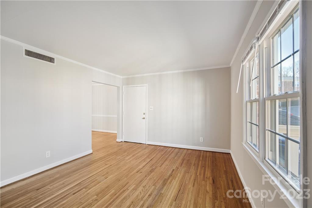 914 McAlway Road Charlotte, NC 28211 - Photo 8 of 44 a view of an empty room with wooden floor and a window