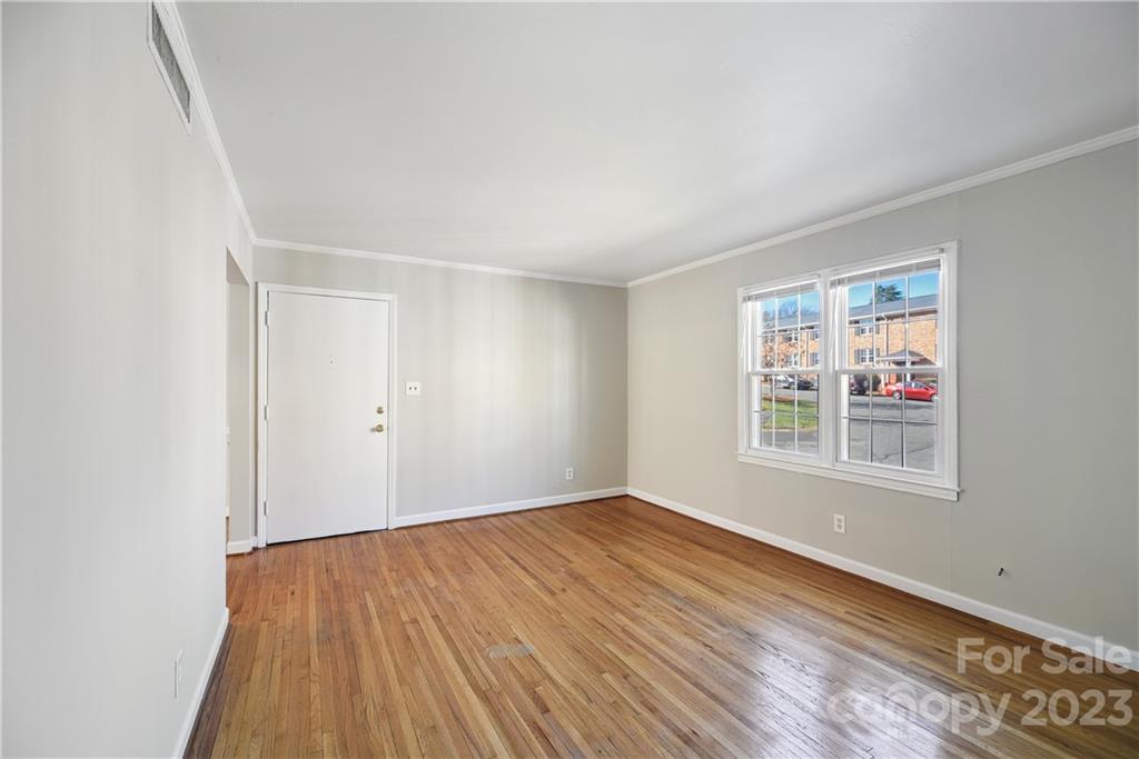 914 McAlway Road Charlotte, NC 28211 - Photo 9 of 44 a view of an empty room with wooden floor and a window