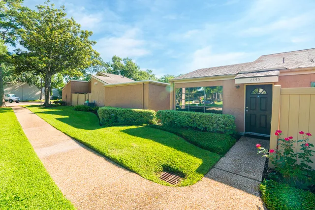 a view of a house with a yard and plants