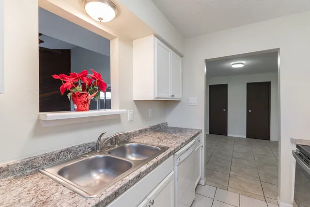 a kitchen with a sink cabinets and window