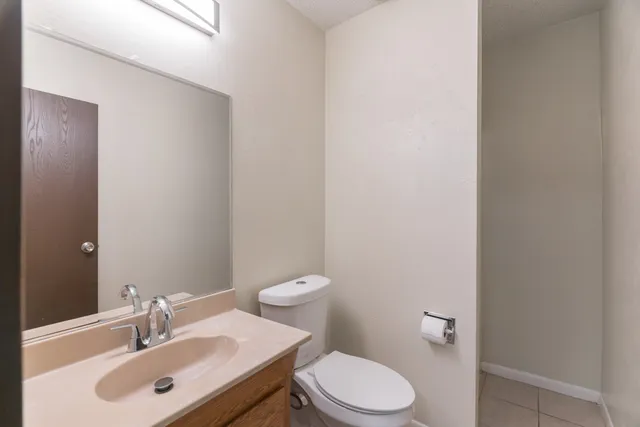 a bathroom with a sink a toilet and a mirror
