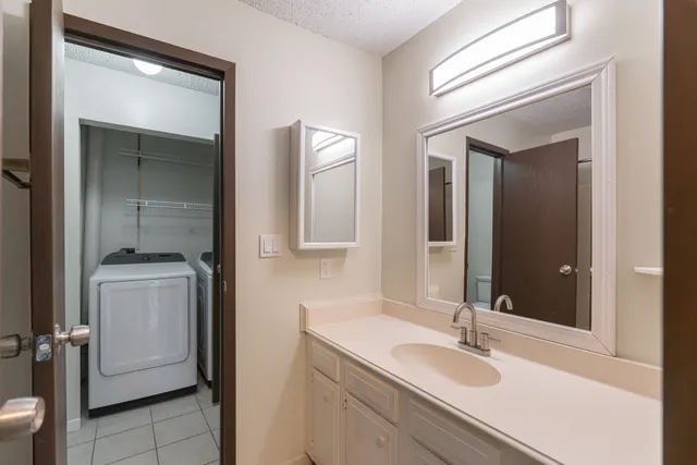a bathroom with a sink and mirror