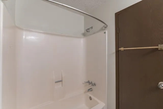 a bathroom with a shower and a bath tub