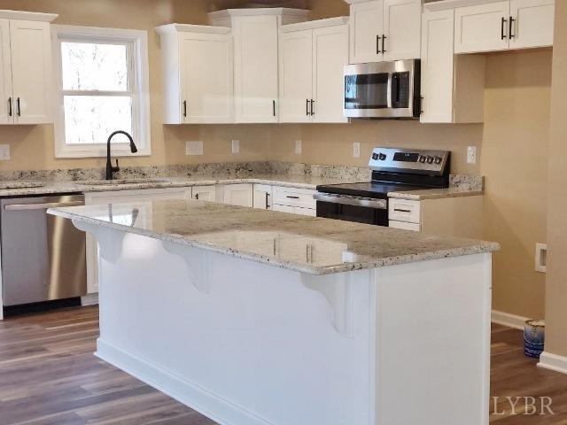 2329 Stonewall Road Concord, VA 24538 - Photo 4 of 15 a kitchen with stainless steel appliances granite countertop a sink a stove and a microwave