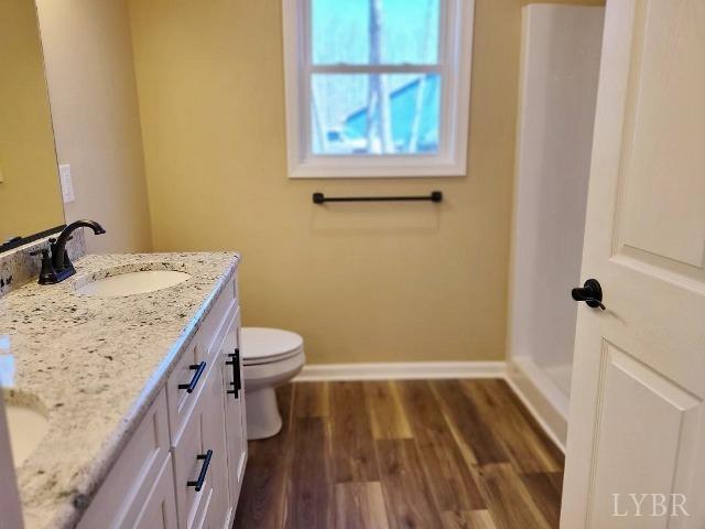 2329 Stonewall Road Concord, VA 24538 - Photo 9 of 15 a bathroom with a granite countertop sink toilet and shower