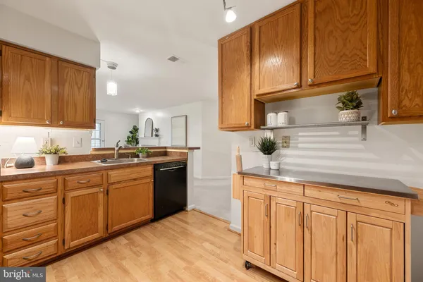 a kitchen with stainless steel appliances a stove sink and microwave