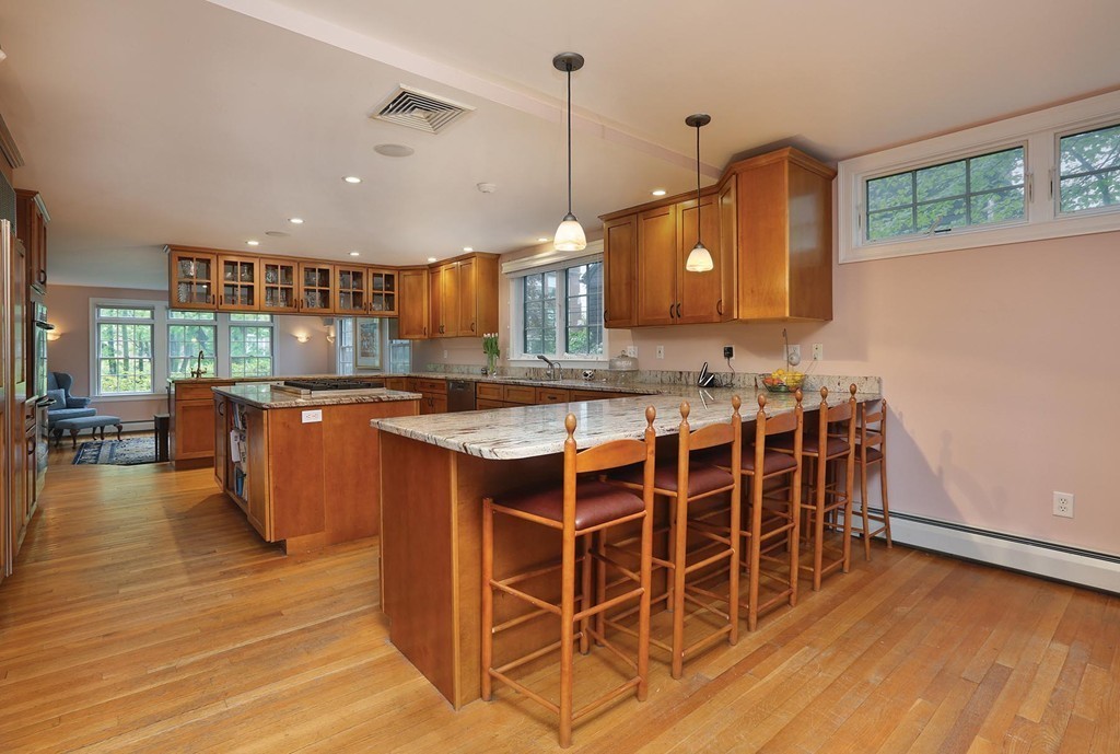 26 Rowena Road Newton, MA 02459 - Photo 3 of 9 a kitchen with kitchen island granite countertop wooden floors and a view of living room
